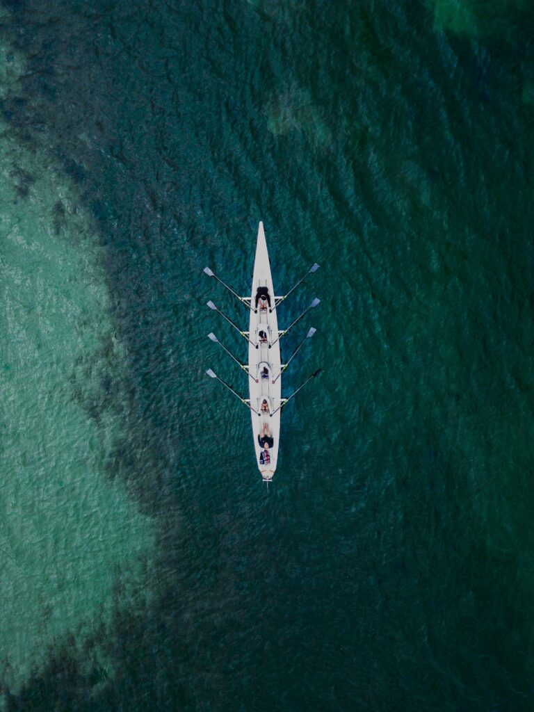 Aerial View of People Swimming on a Canoe on a Sea